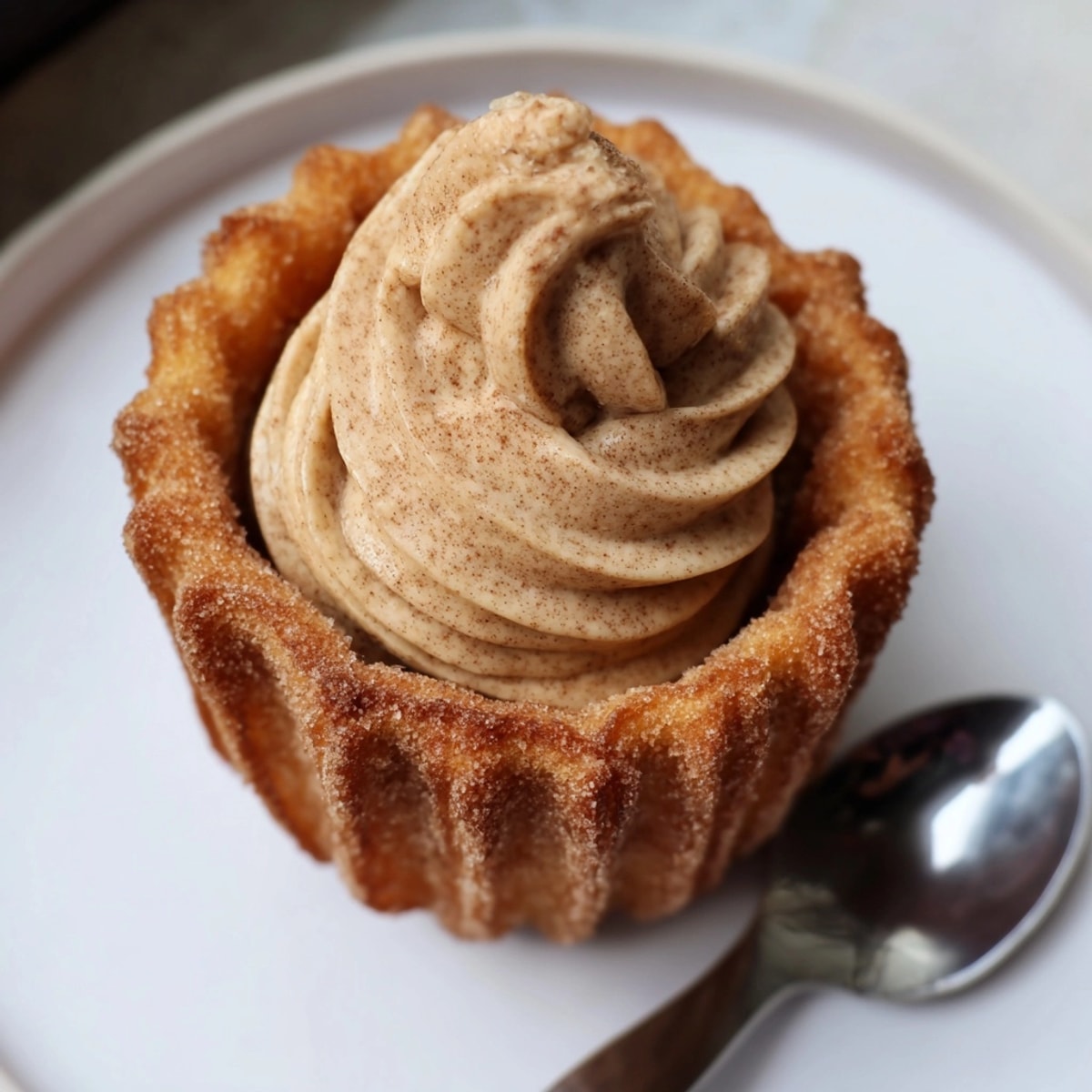 Tazas de tarta de queso con sabor a churro y canela: un postre decadente y cremoso.