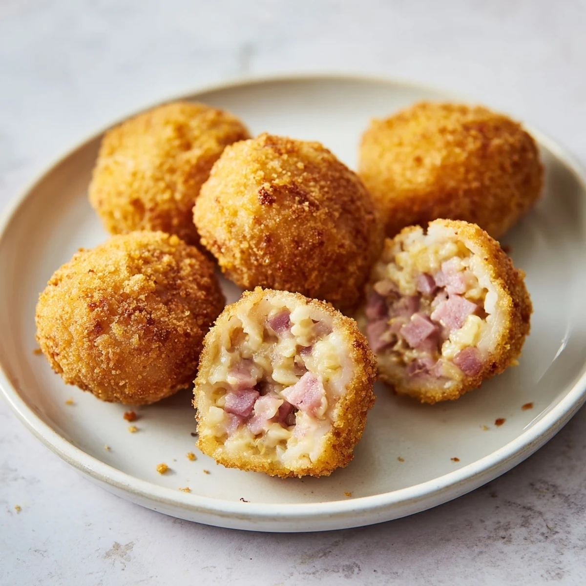 Golden, crispy homemade croquettes ready to eat, served hot after deep frying.