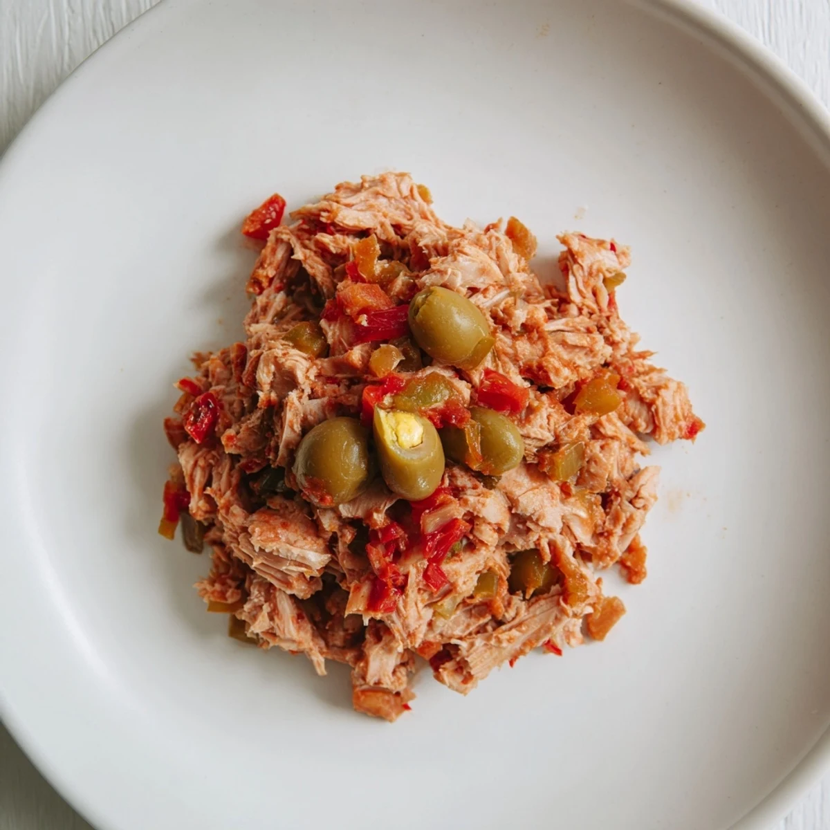 Golden-brown tuna empanada filling, a savory mix of vegetables and spices, ready to be wrapped.