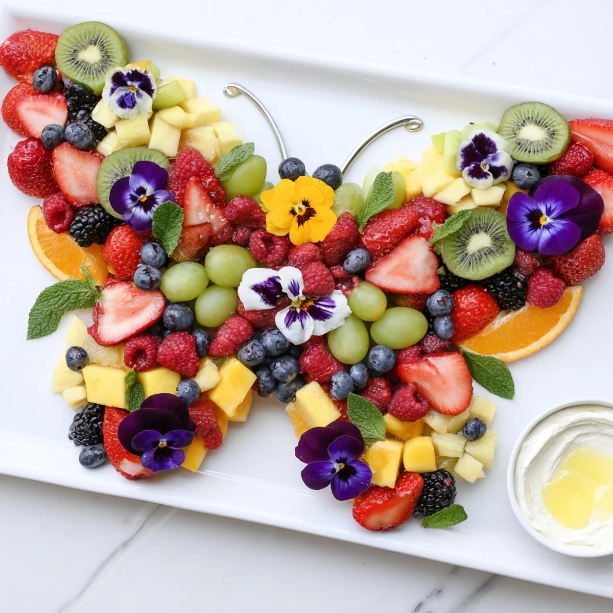 Vibrant Butterfly Garden Fruit Board: Strawberries, blueberries, and more are artfully displayed for a party.