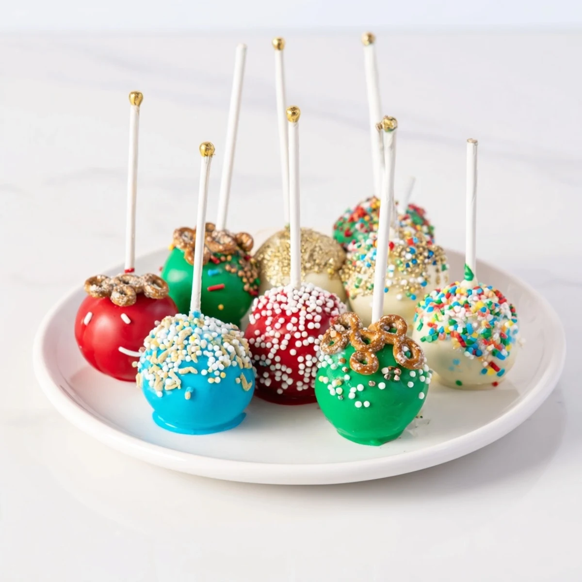 Festive ornament ball cake pops, colorful and coated, ready for the holiday season enjoyment.