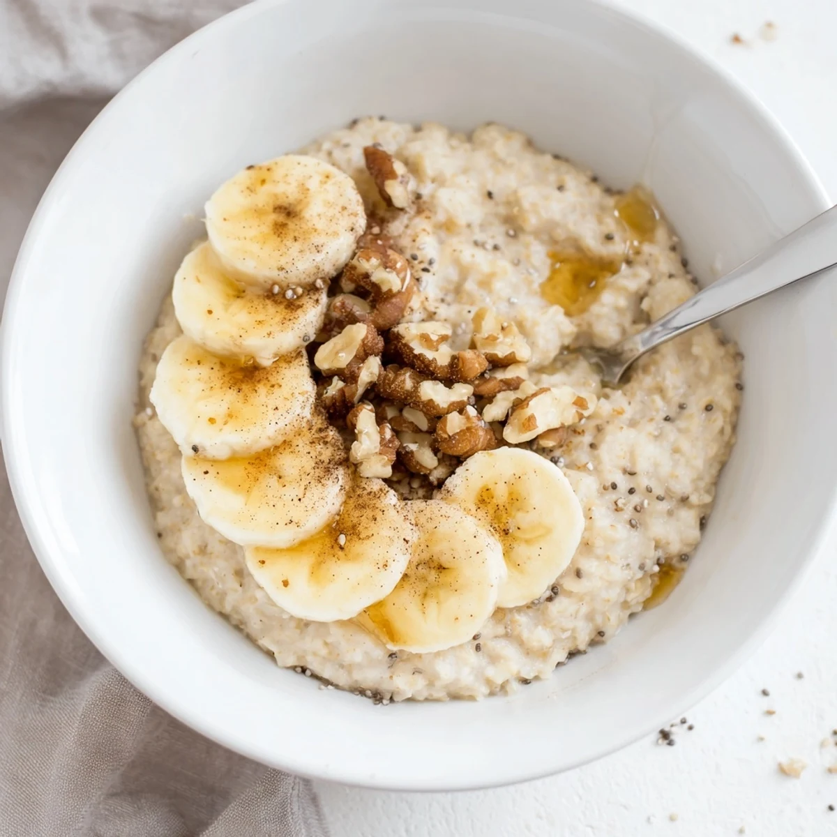 Creamy microwave banana oats, topped with fresh banana slices, ready for a warm and quick breakfast.