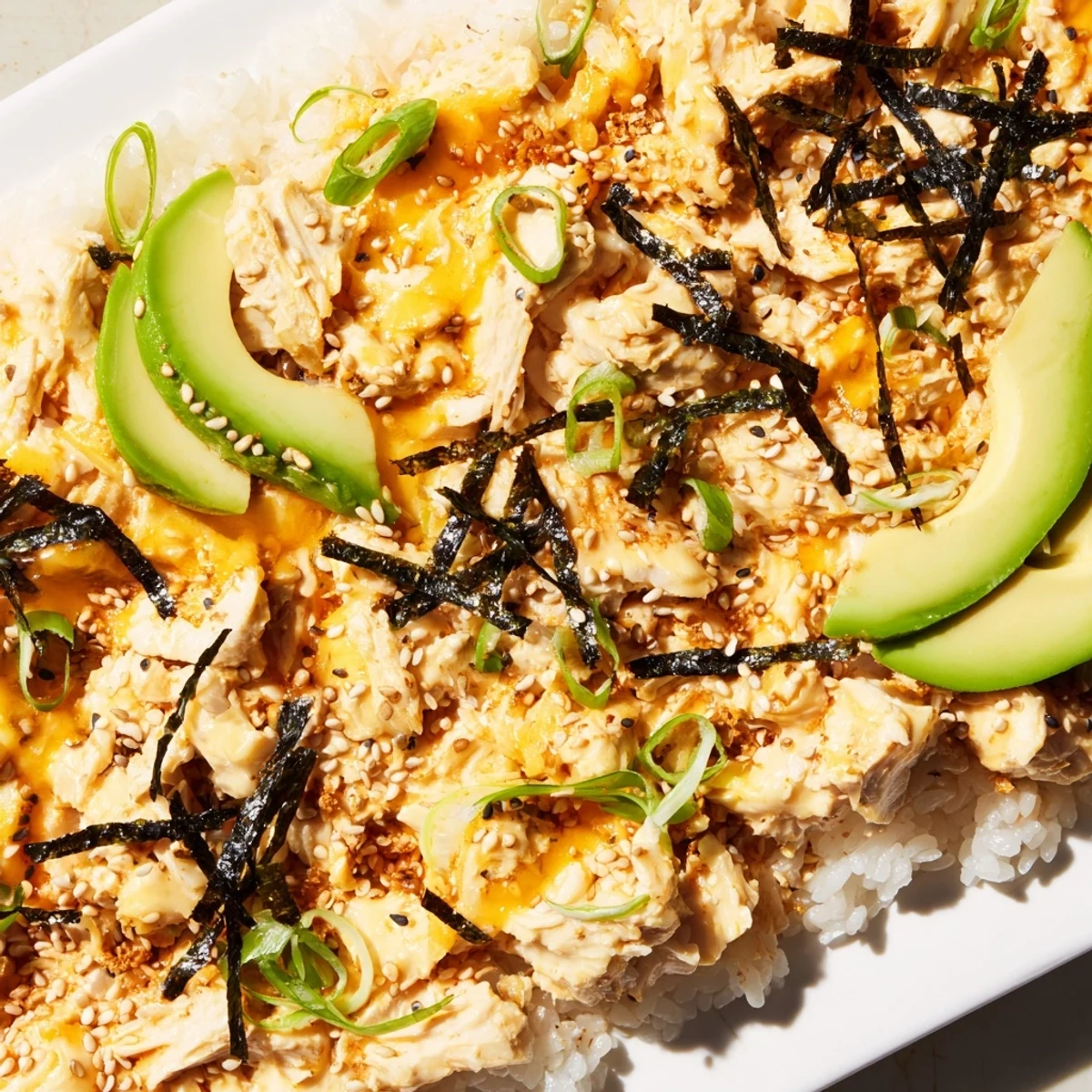 This Chicken Sushi Bake shows a savory, shareable dish, layered with chicken and mozzarella cheese.