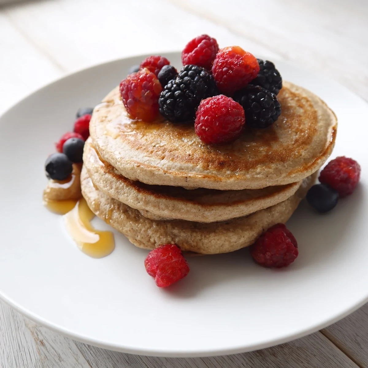 Close-up of golden brown banana pancakes, perfect for dipping in fresh maple syrup.