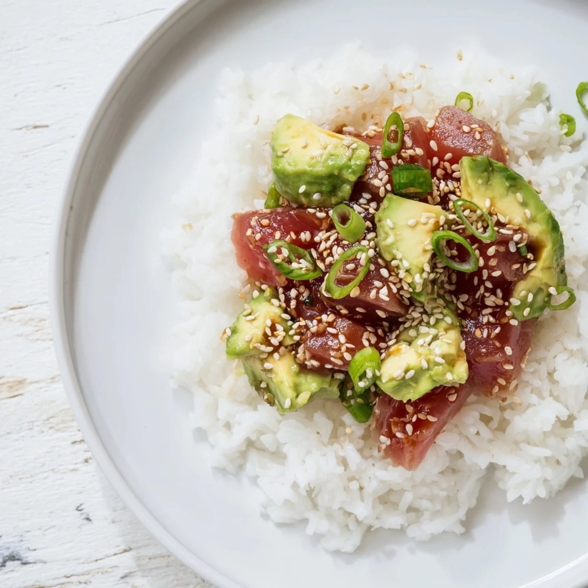 Tuna avocado rice bowl: a fresh, colorful view of diced avocado and tuna over fluffy rice.