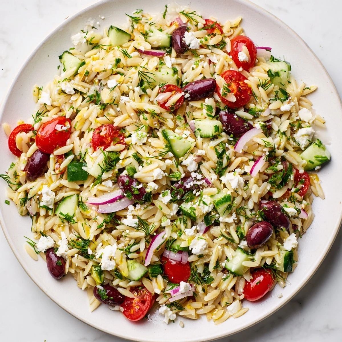 This colorful Greek Orzo Salad features perfectly cooked orzo and a bright lemon dressing.
