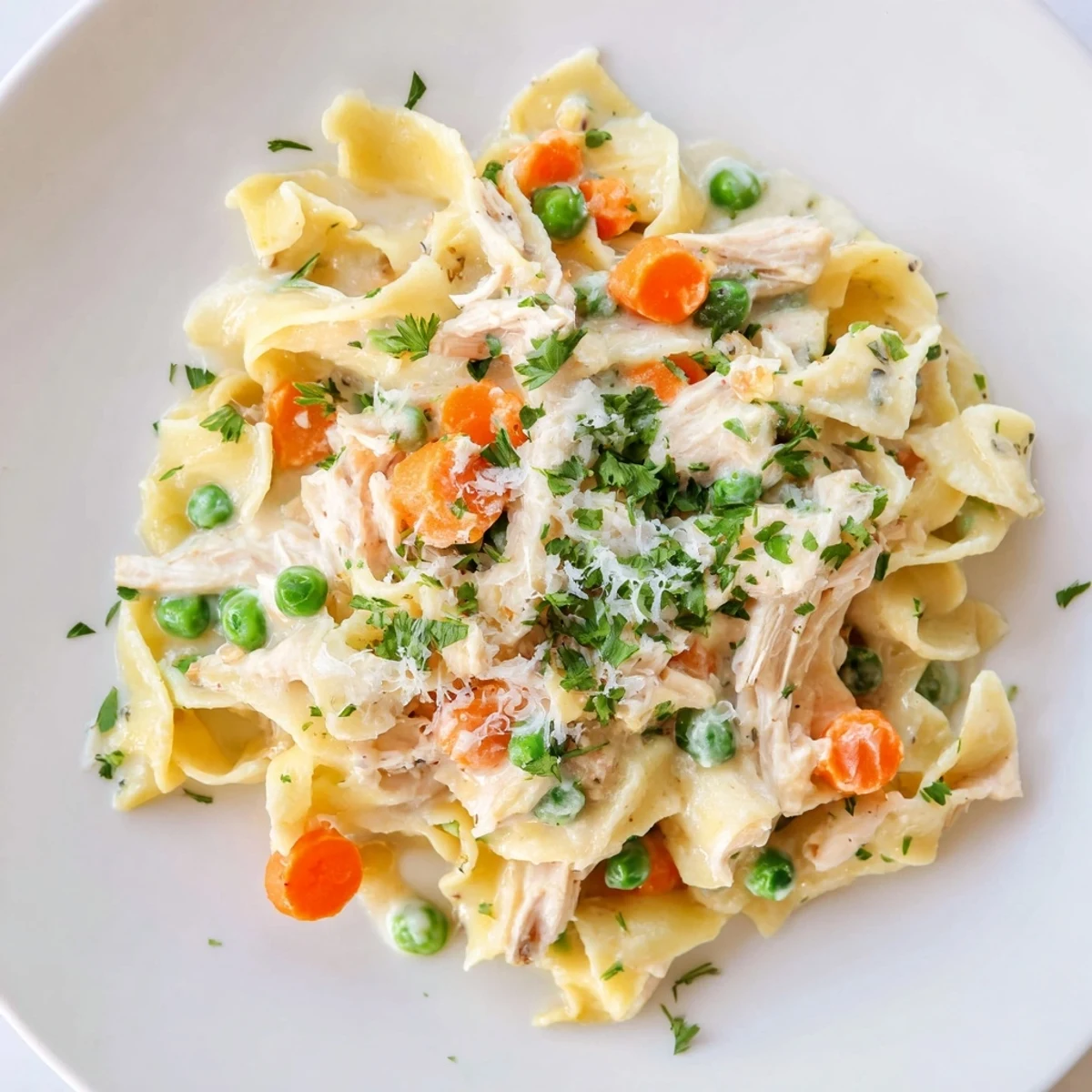 Freshly cooked Spring Chicken Noodle Skillet with visible egg noodles and bright green peas.