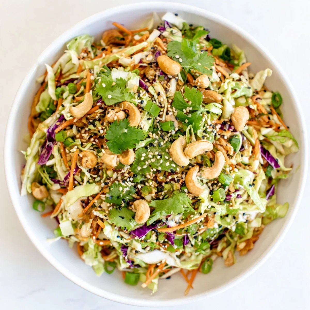Healthy vegan Asian Cabbage Salad tossed with red cabbage, carrots, and sesame seeds.