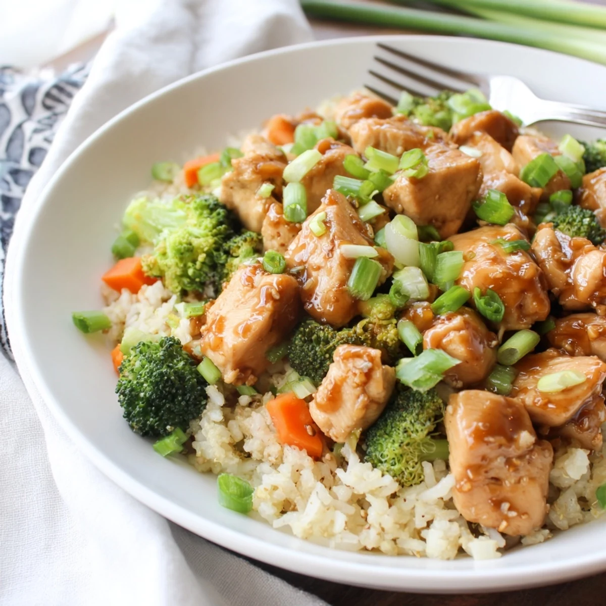 Tender chicken pieces nestled in fluffy rice with crisp broccoli florets in a glossy honey garlic sauce.  