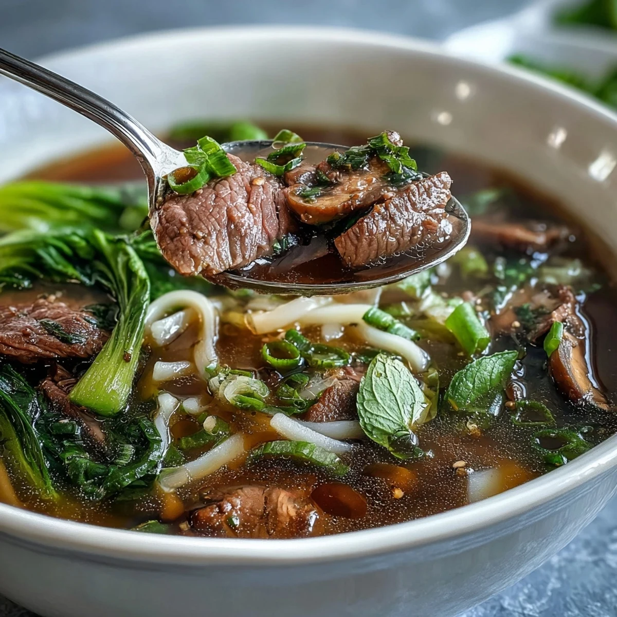 Asian Hot Pot Noodle Feast with aromatic broth, beef, and vegetables steaming in a tabletop pot.