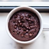 Steaming chocolate mug cake, a quick American dessert, topped with optional chocolate chips.