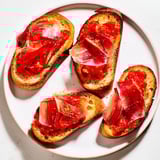 Freshly made pan con tomate, with juicy tomatoes and salty jamón, perfect appetizer.