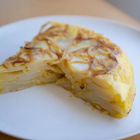Golden-brown Simplified Tortilla de Patatas slices, a Spanish potato and egg omelet ready to savor.
