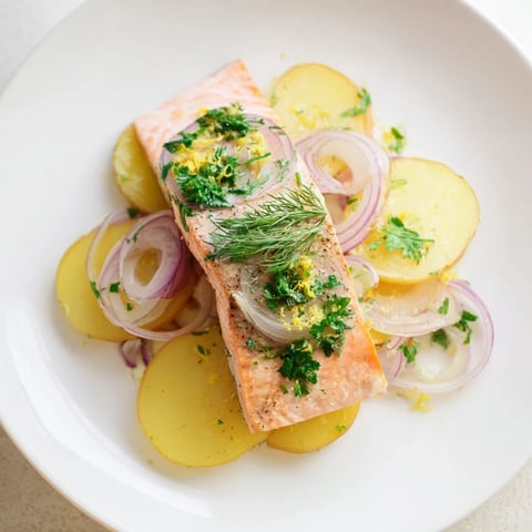 Golden, flaky Budget One-Pan Salmon with tender potatoes, herbs and a squeeze of lemon.