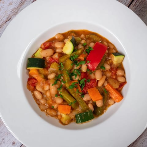 Healthy Bean Stew with Vegetables simmering in a pot with vibrant, garden-fresh vegetables.