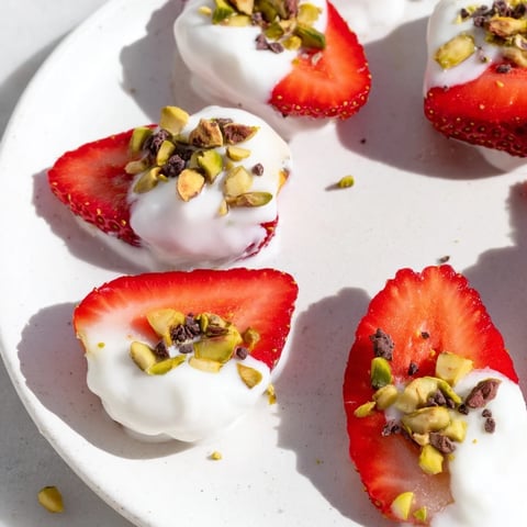 Yogurt Dipped Strawberry Half-Circles, fresh strawberries partially submerged in creamy yogurt, a delightful dessert.