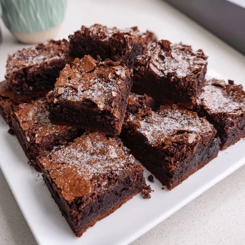 Fudgy brownie squares dusted with powdered sugar, ready to be enjoyed!