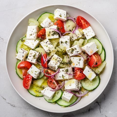 A colorful Sun-Drenched Patio mezze board with feta, olives, and fresh vegetables ready to eat.