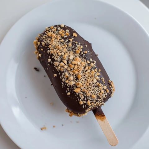 Frozen Banana Chocolate Pops, coated in rich chocolate and crunchy peanuts, make a perfect dessert.