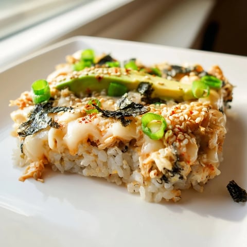 Chicken Sushi Bake, a baked casserole featuring fluffy rice, creamy chicken, and a golden cheesy top.