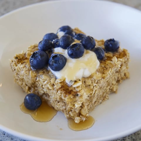 Fluffy Protein Pancake Oats, baked until golden brown, served with fresh blueberries on top.