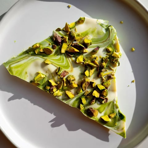 Creamy white chocolate Pistachio Matcha bark, swirled with green matcha and crunchy pistachios, a treat.