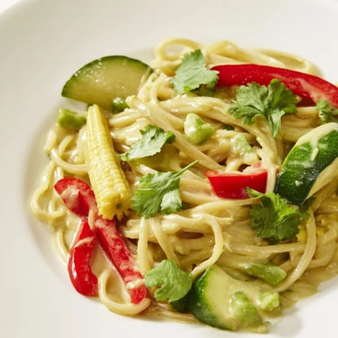 A steaming bowl of Thai Curry Pasta, a colorful fusion of flavors and textures.