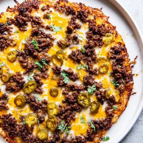 Juicy Spicy Ground Beef Pizza, overflowing with melted cheese and ready to eat.