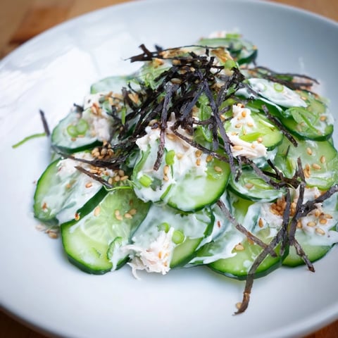 California Roll Cucumber Salad: chilled and refreshing, showcasing vibrant cucumber slices and imitation crab.