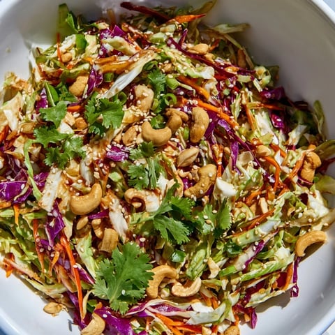 Asian Cabbage Salad with fresh crunchy vegetables and chopped peanuts in a sesame-ginger dressing.