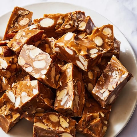 Golden-hued Budget Spanish Nougat Brittle, full of crunchy nuts, perfect for holiday snacking.