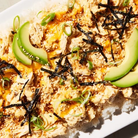 This Chicken Sushi Bake shows a savory, shareable dish, layered with chicken and mozzarella cheese.