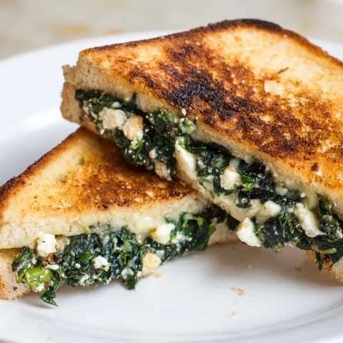 Perfectly toasted Feta & Spinach Stuffed Grilled Cheese; imagine the savory spinach and feta filling inside.