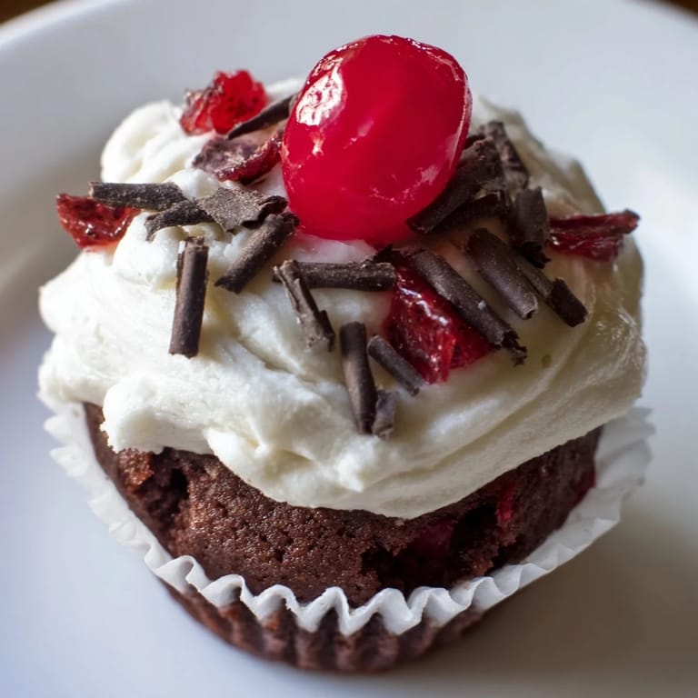 Moist Rocky Cherry Mini Cupcakes with Aged Cream, with glistening cherry halves on top.