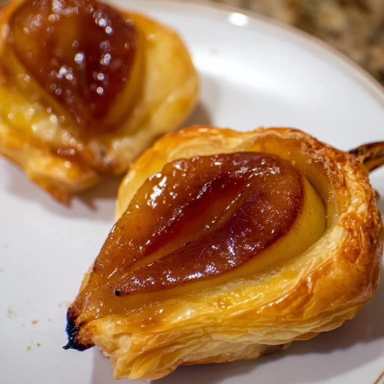 Warm, inviting image: buttery puff pastry topped with delicious, caramelized Pear Tarte Tatin.