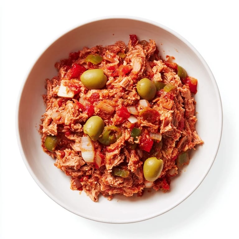 A close-up shot of the 3-step tuna empanada filling: chunky and aromatic, ideal for dinner.