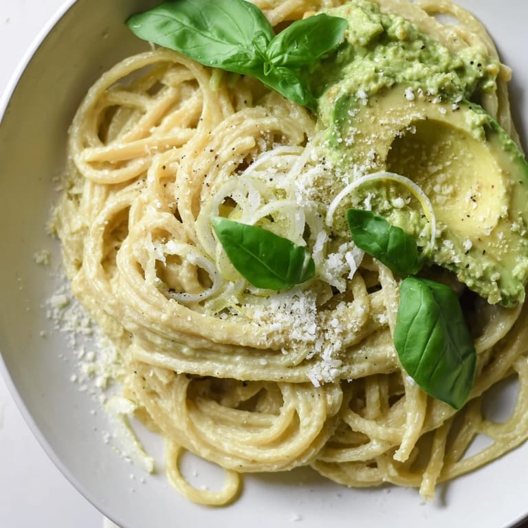 Close up of creamy avocado pasta, a simple Italian-inspired dish bursting with flavor.