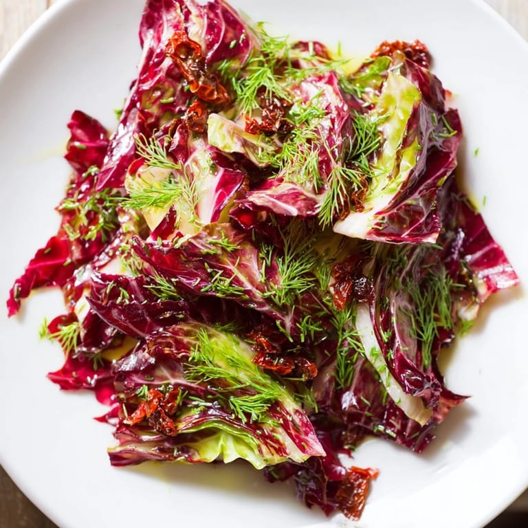 Freshly tossed Cabbage Salad With Sundried Tomatoes showcasing a medley of red and green cabbage, carrots, and herbs in a light, fragrant vinaigrette.